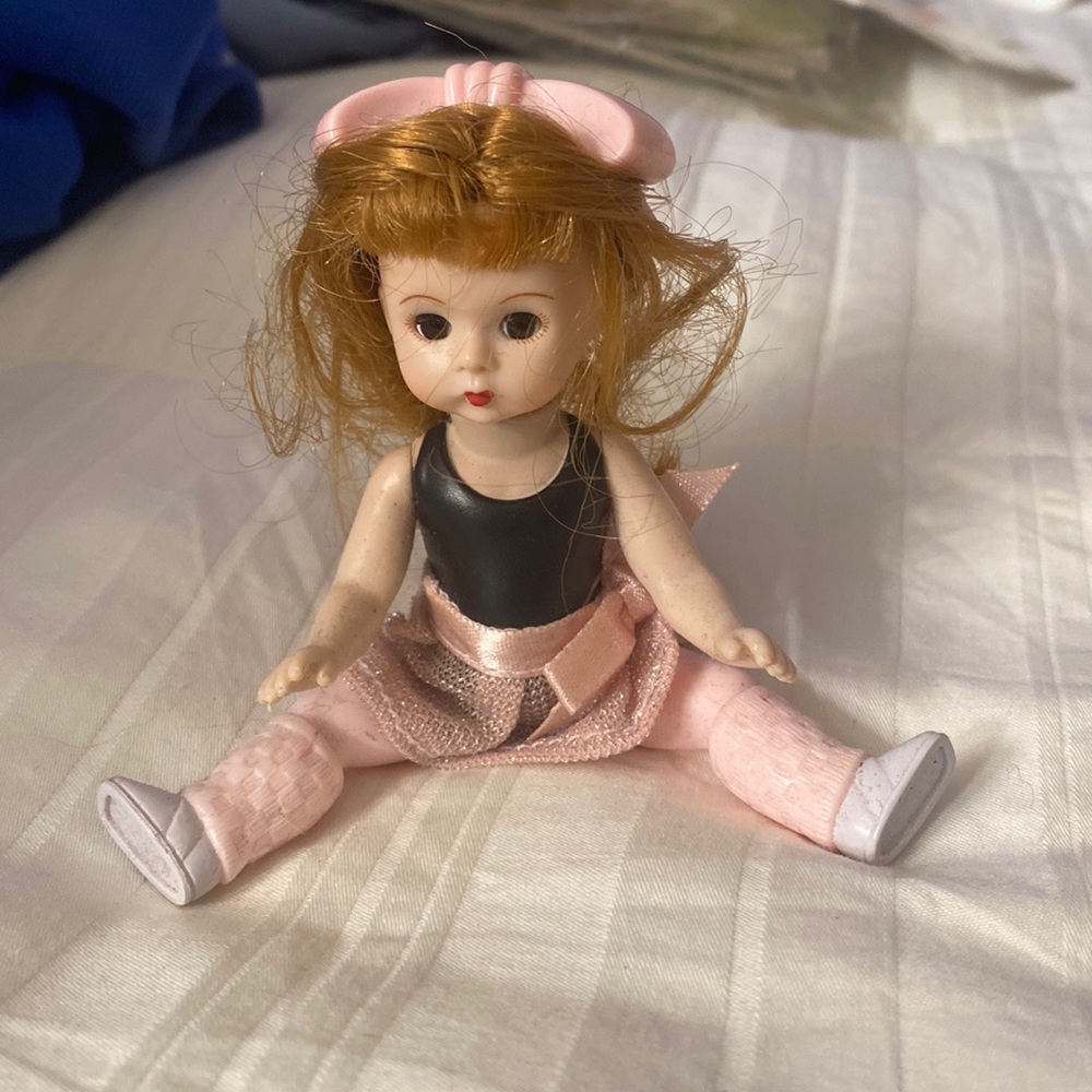 Porcelain ballerina doll with red long hair, pink outfit, &bow w/black bodysuit